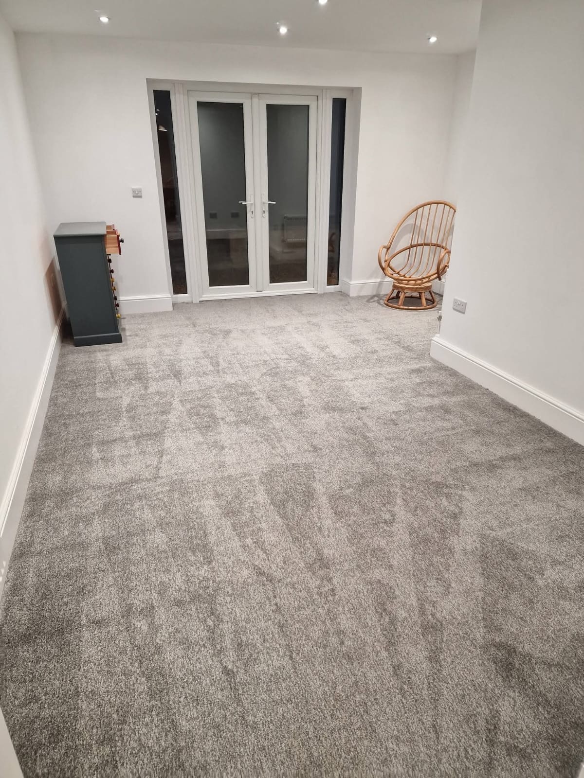 Freshly cleaned grey carpet in a bright lounge